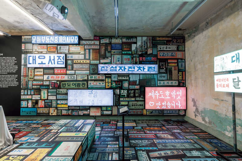 “城市与文字”展厅一角摆满了来自韩国各地的招牌。“外卖的民族”迄今制作的大部分字体，包括2012年发布的第一款字体——“Hanna体”，都借鉴了这些朴实又有情怀的旧招牌。